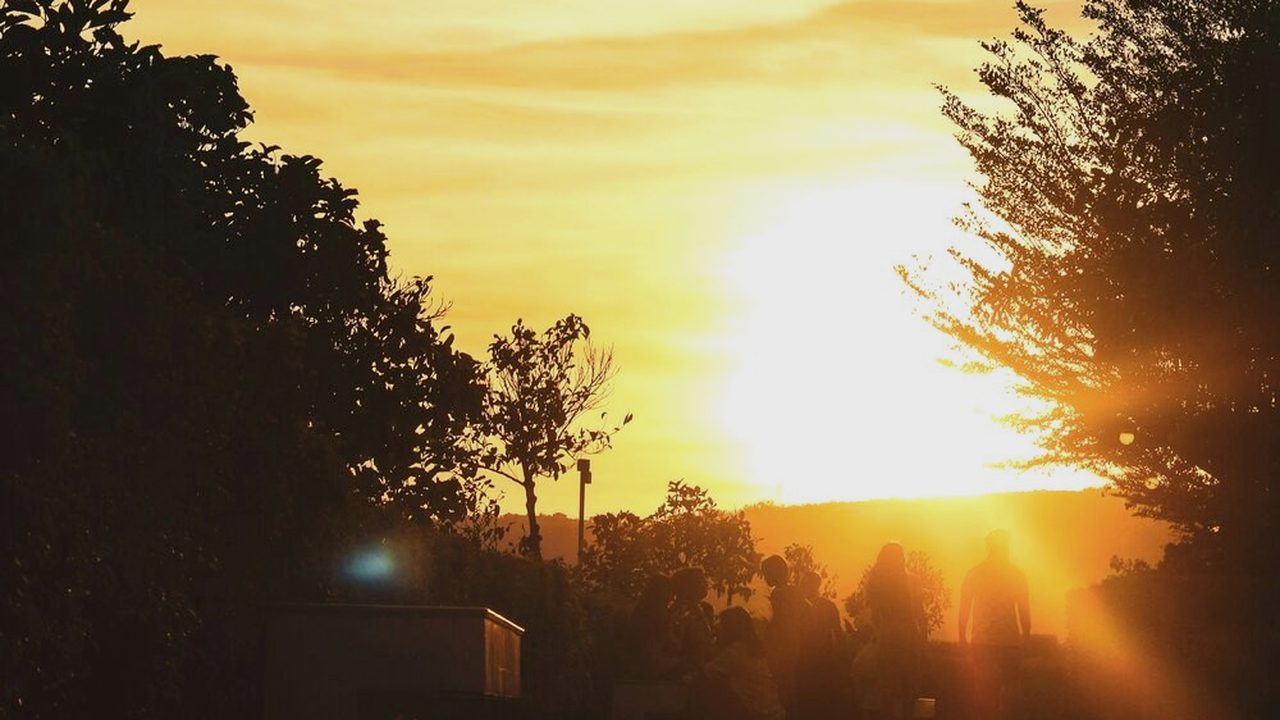 A boardwalk leading toward sunset with walkers in silhouette — Past The Wall, the 12-week workbook