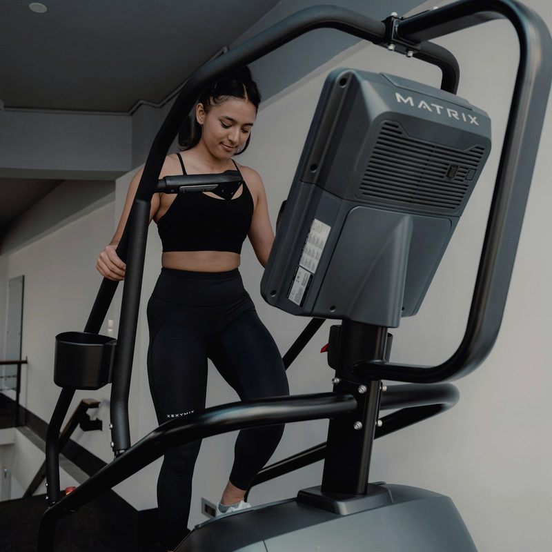 A walker on a consumer treadmill in soft light — Treadmill Edition, the indoor protocol